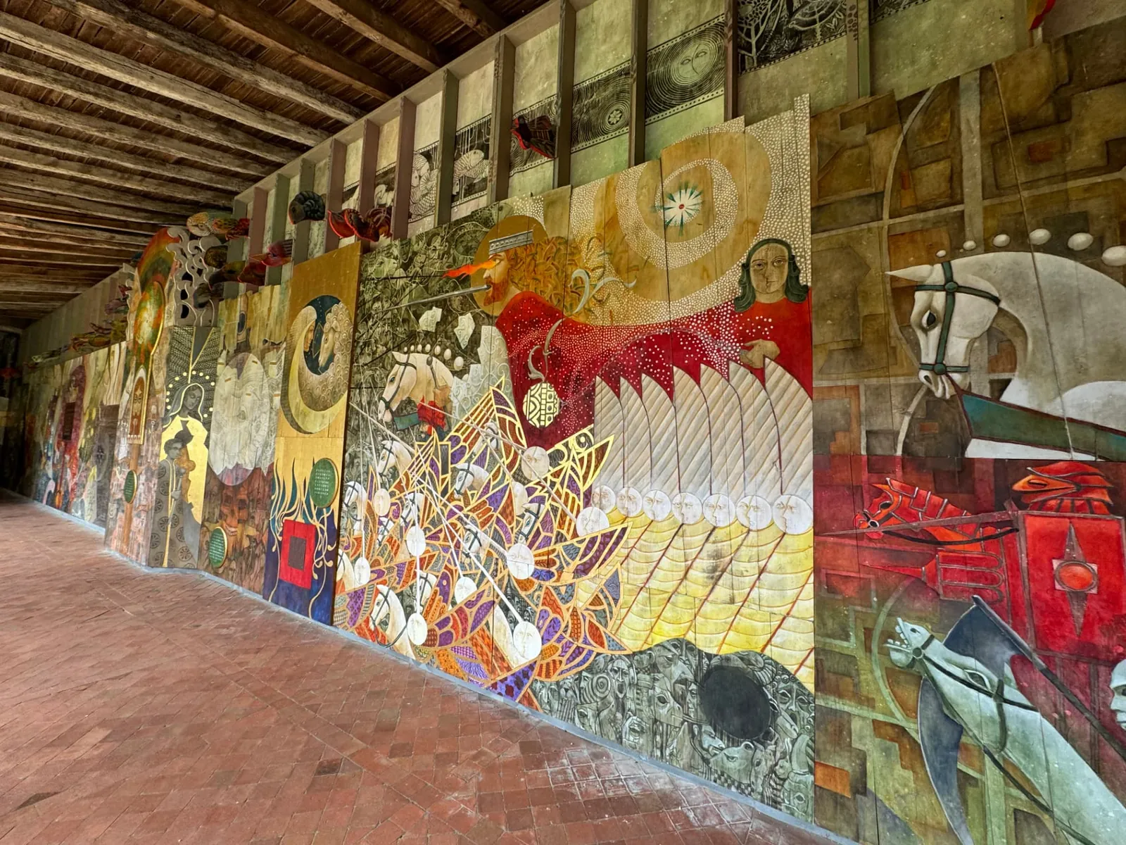 Painted murals lining the cloister corridor in Saint-Émilion