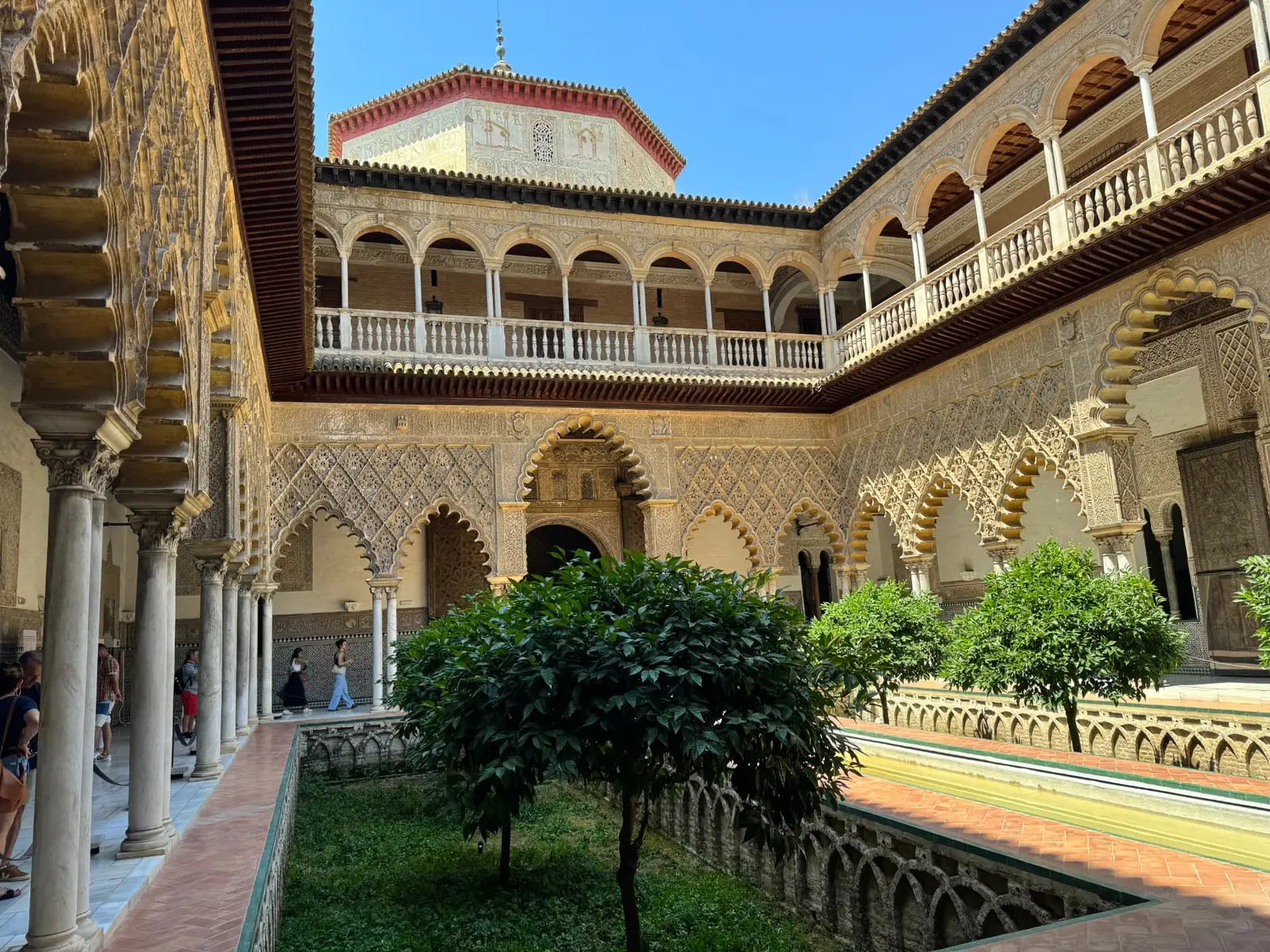 Carved arches and a reflecting pool in the Royal Alcázar of Seville