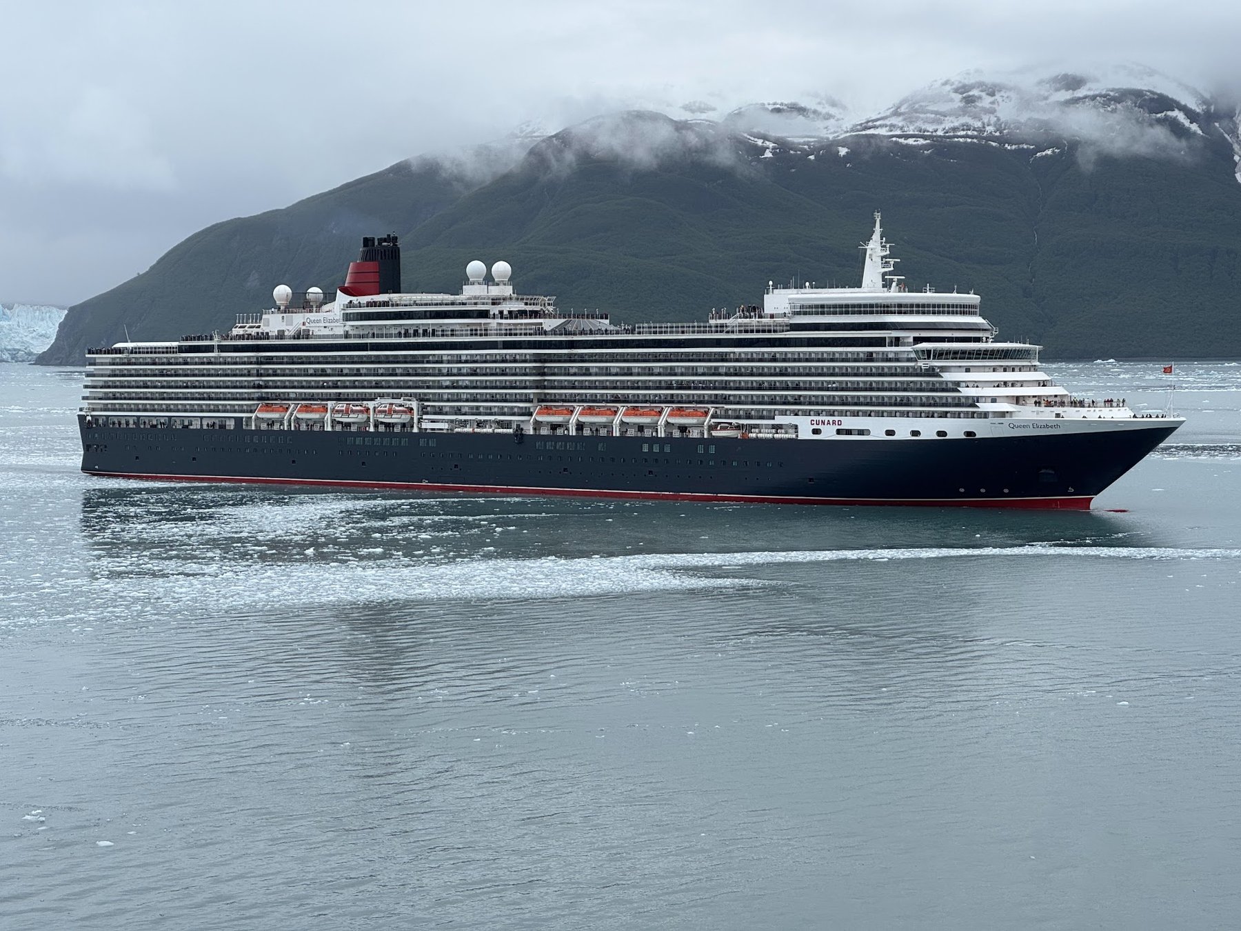 Luxury cruise ship in front of an Alaskan glacier