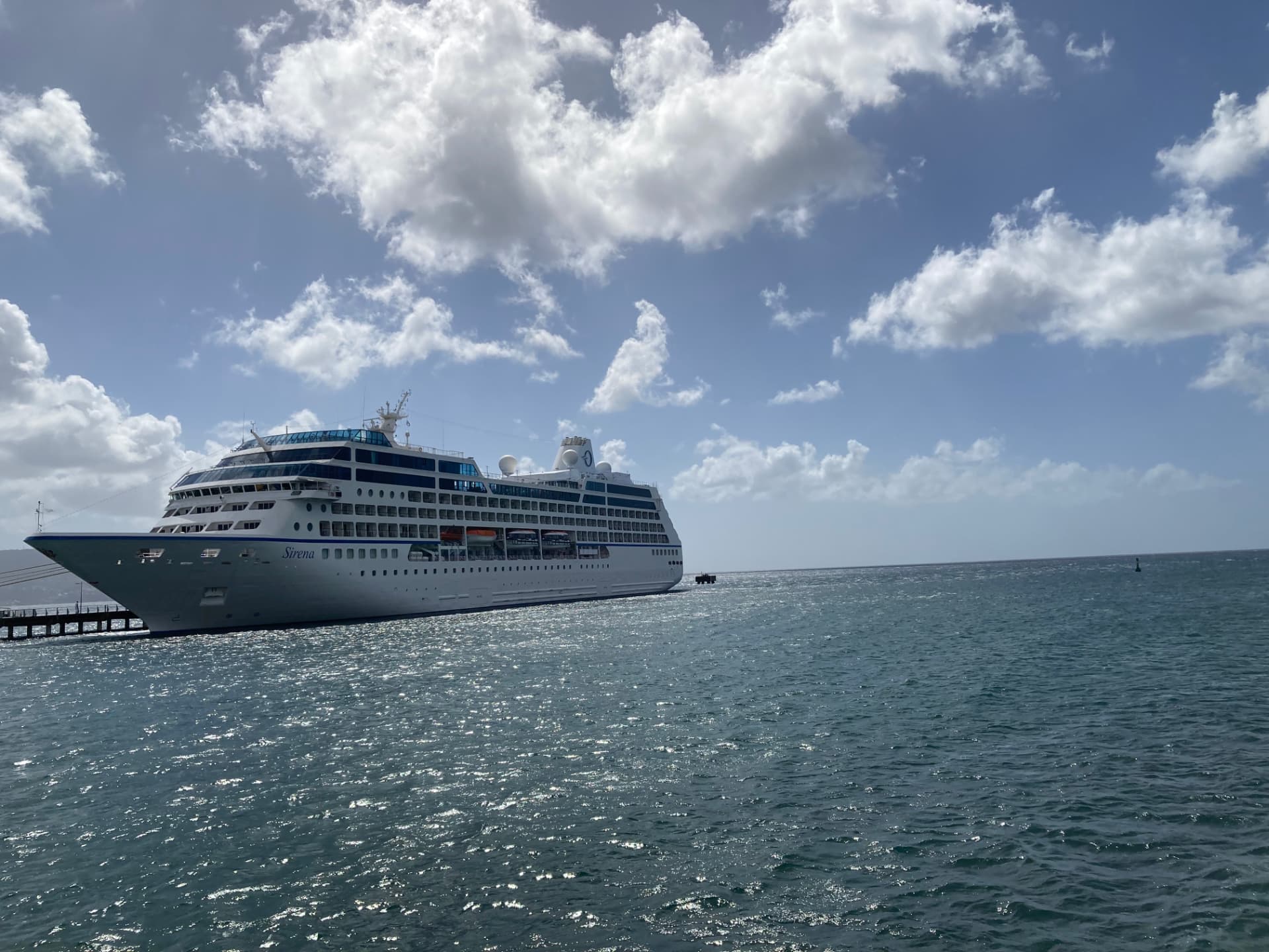 Oceania Sirena docked in the Caribbean under a bright blue sky