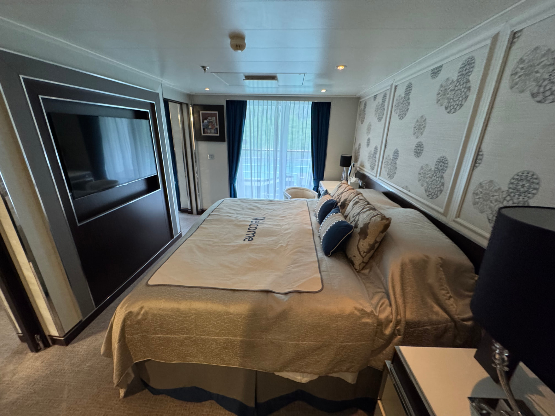 Regent Seven Seas Explorer penthouse suite bedroom with a welcome throw on the bed