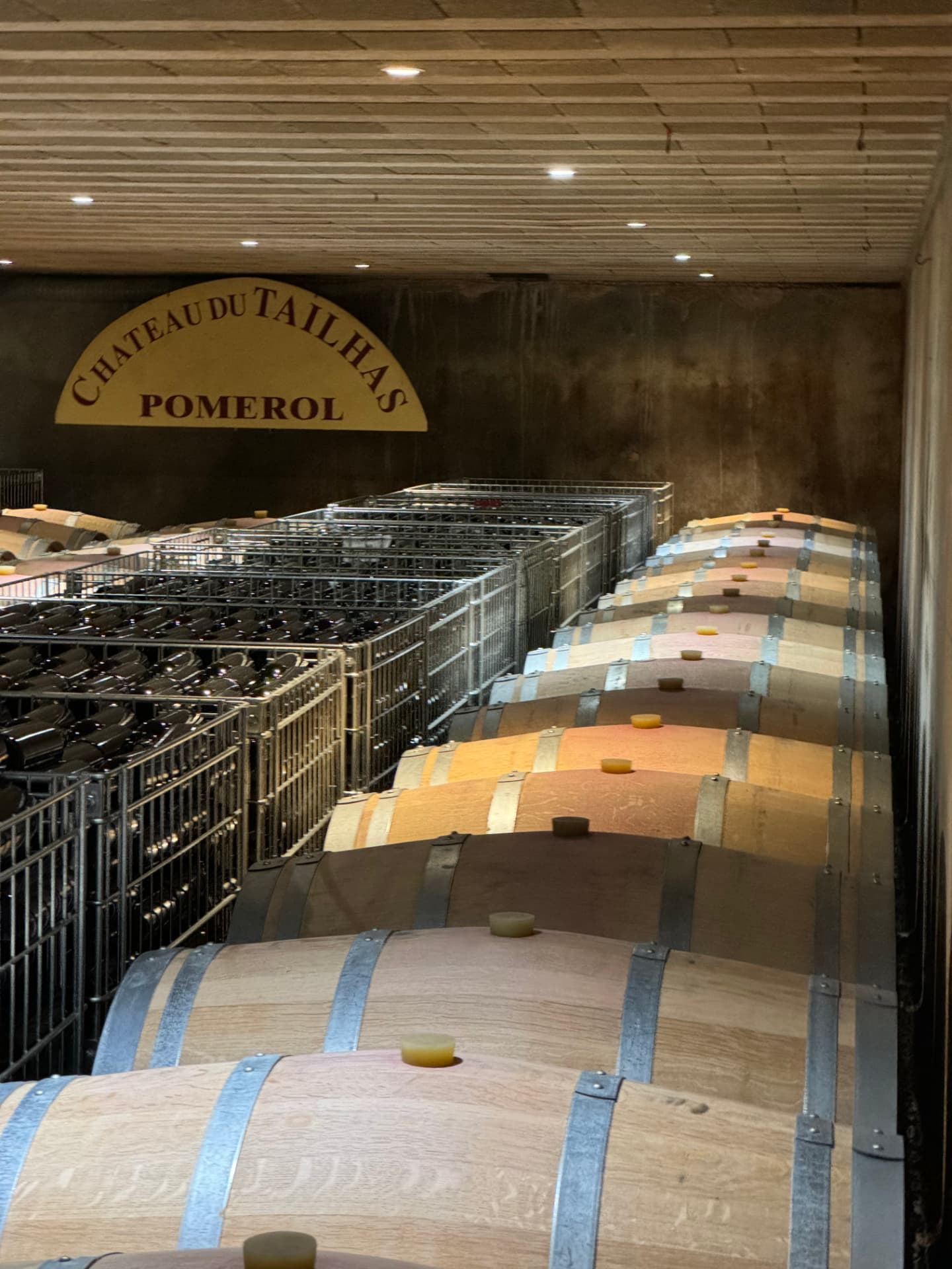 Barrels and bottle racks in a Pomerol cellar