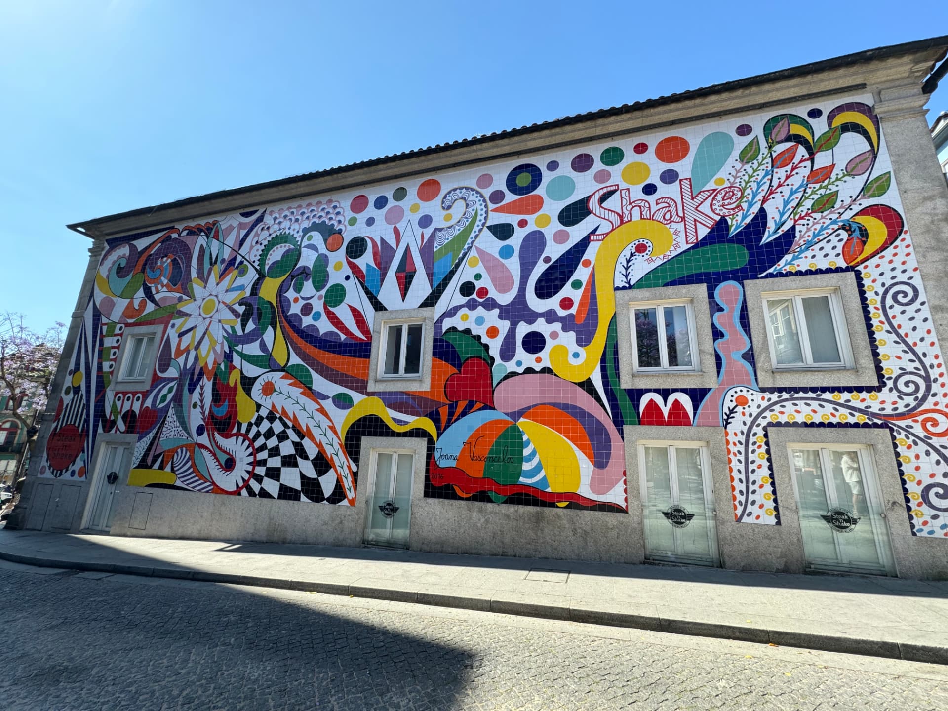 A colorful tiled mural covering a building facade in Oporto