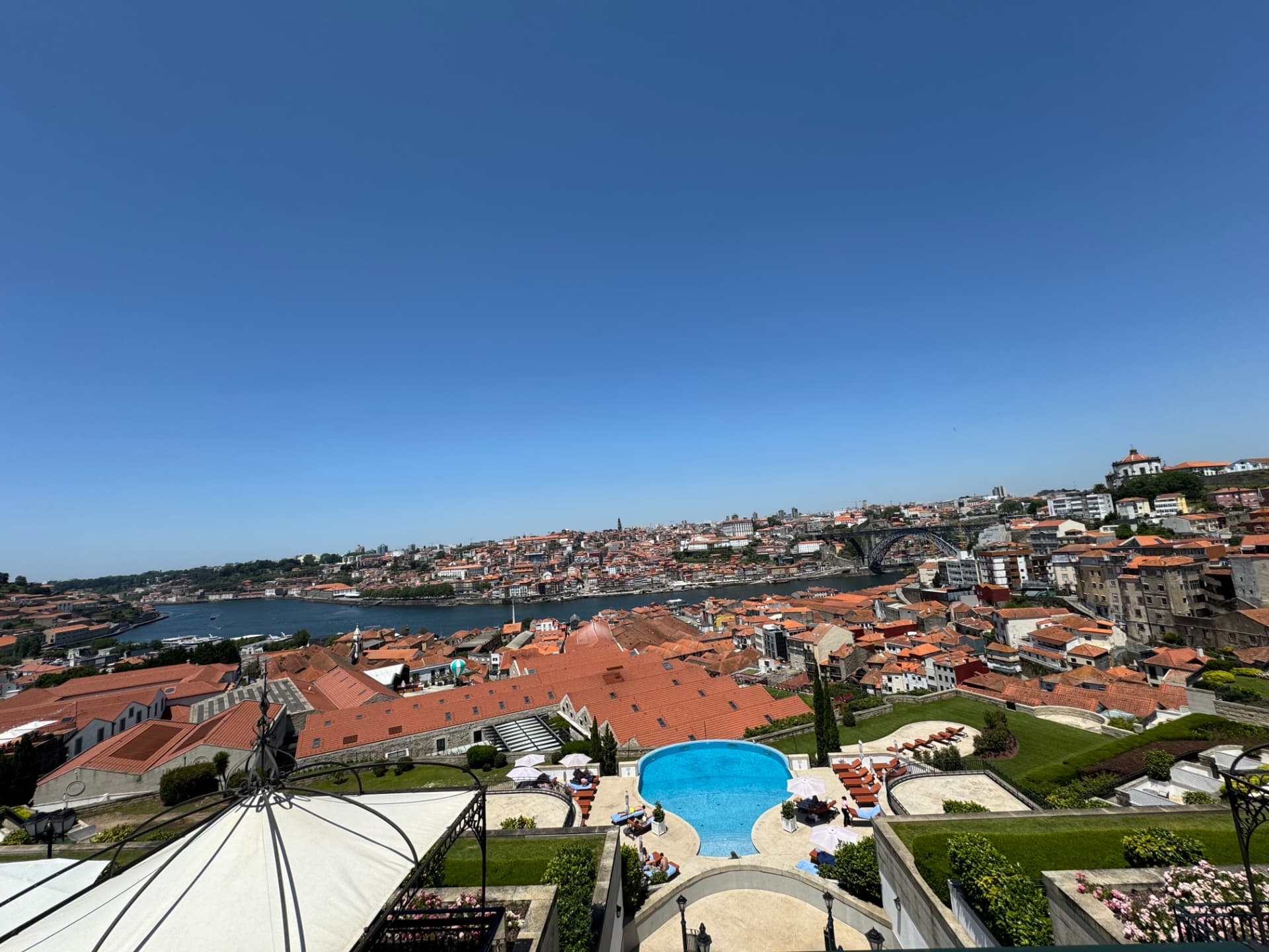 View over the Douro, the Dom Luís I Bridge, and Porto's rooftops from a port lodge terrace