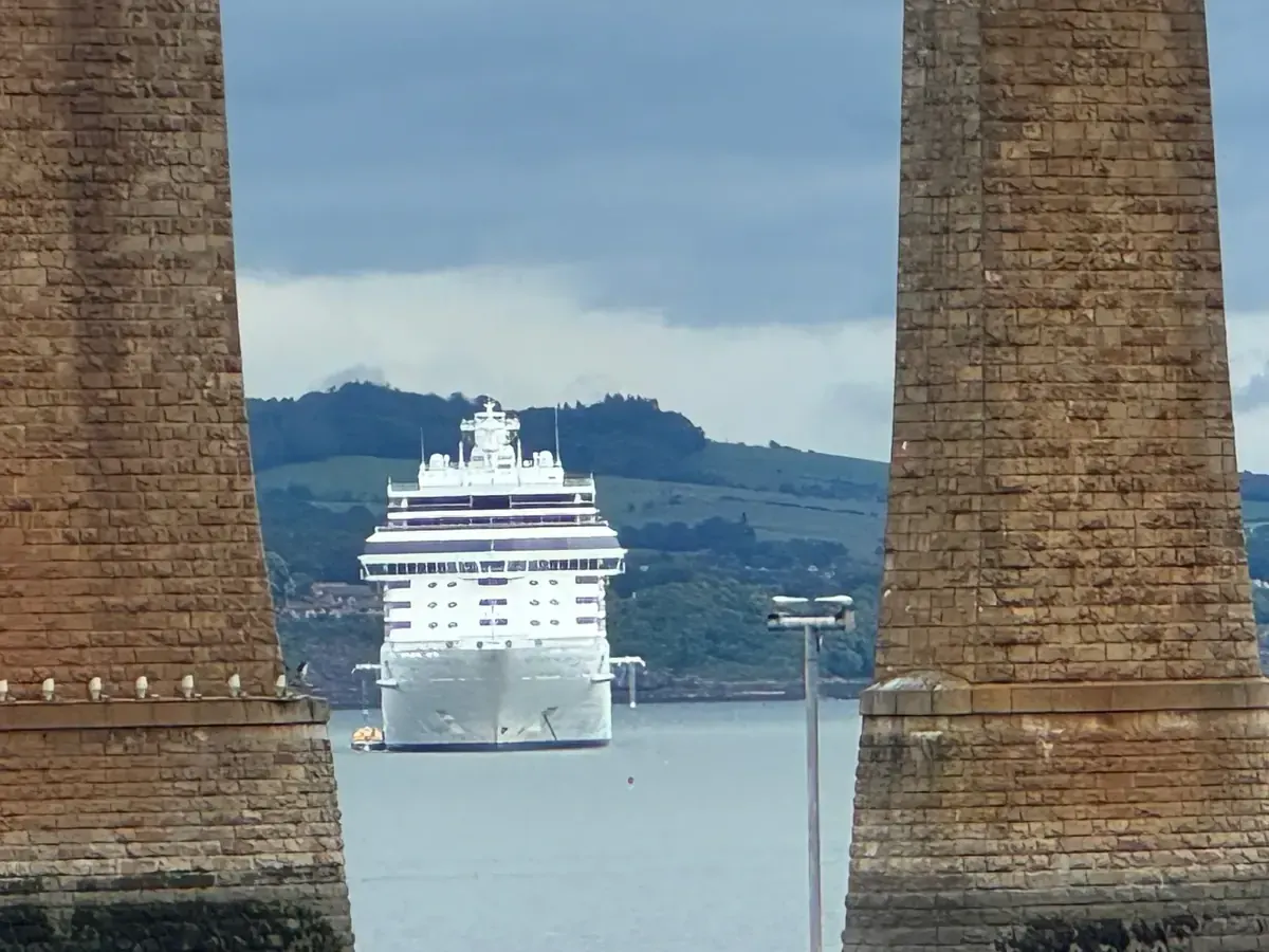 A Regent Seven Seas ship photographed through a bridge structure