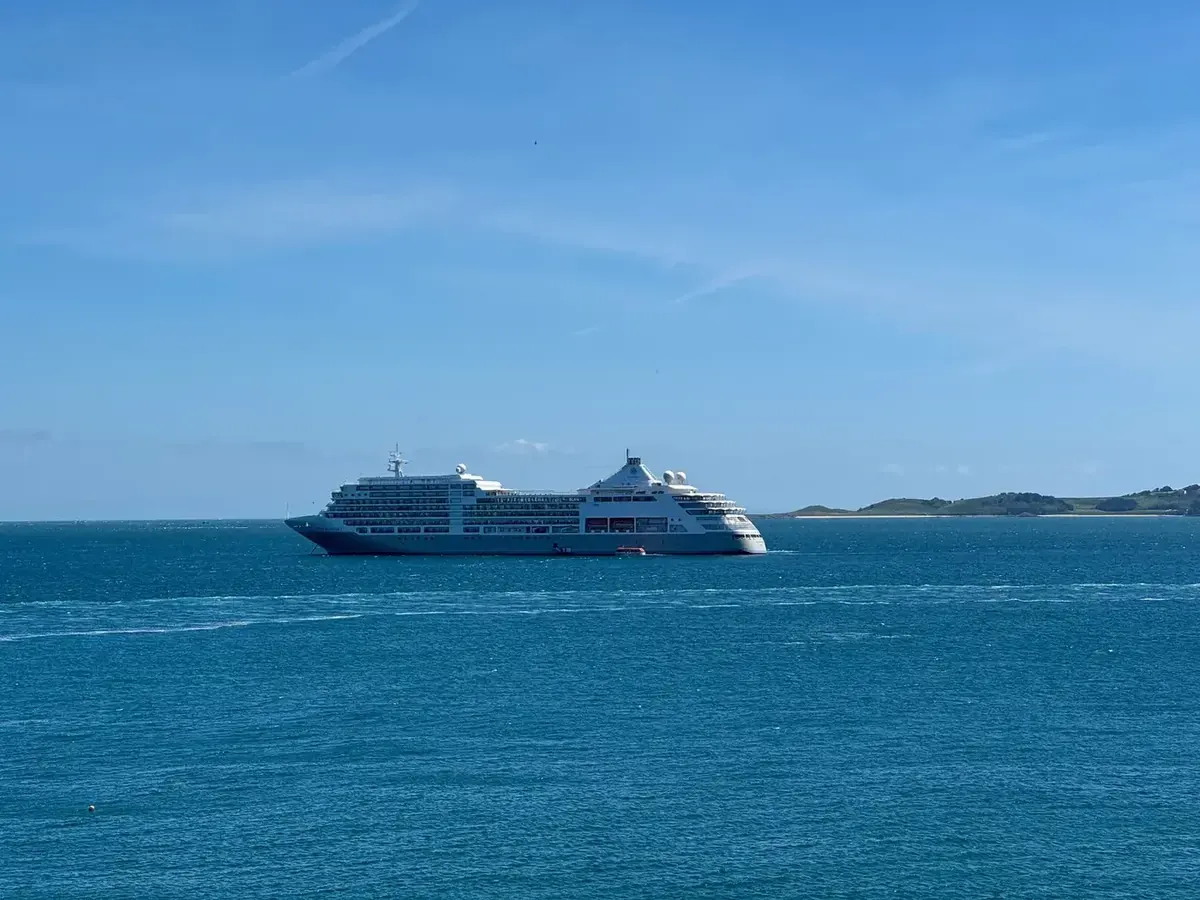 A Silversea ship sailing across bright blue water