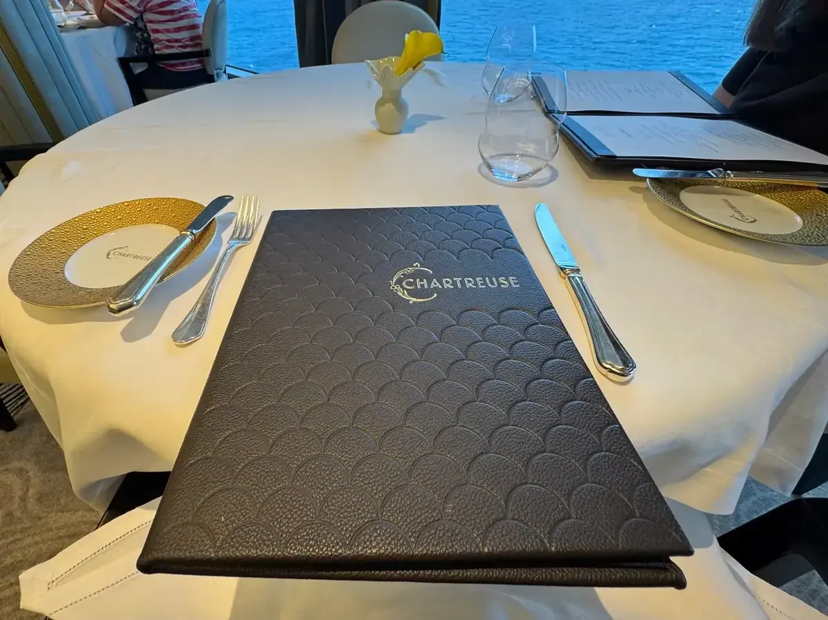 Chartreuse menu on a set table aboard a Regent Seven Seas ship