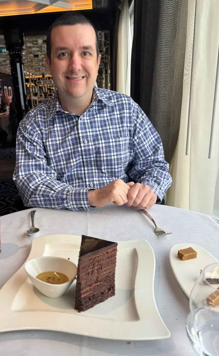 Ben at Prime 7 aboard Regent Seven Seas with the 14-layer chocolate cake