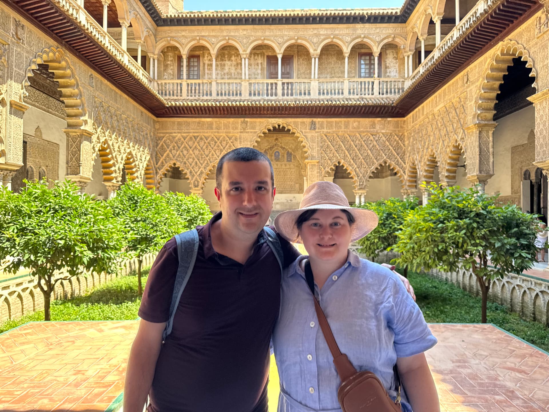Ben and his wife in a tiled courtyard at the Alcázar of Seville