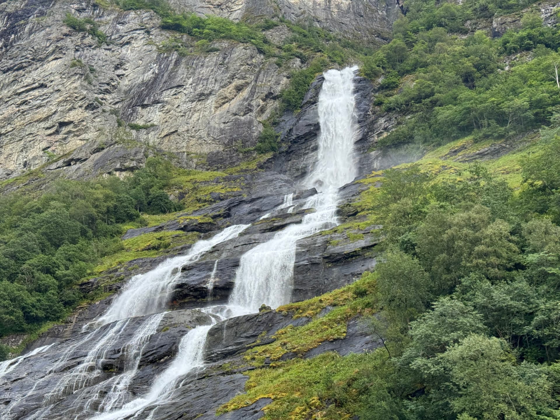 Waterfall tumbling down the rock walls of Geirangerfjord