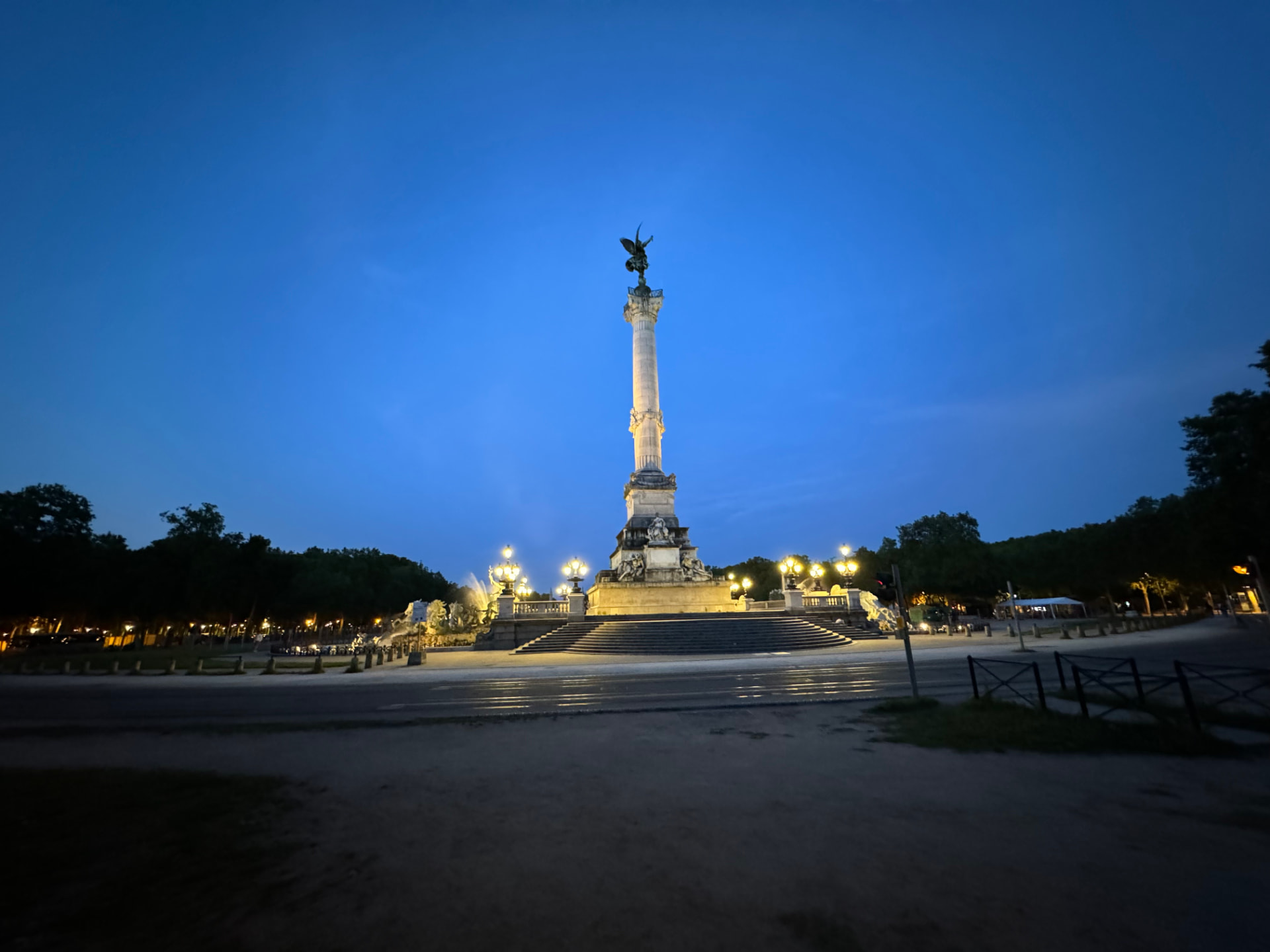 The Monument aux Girondins column illuminated at blue hour