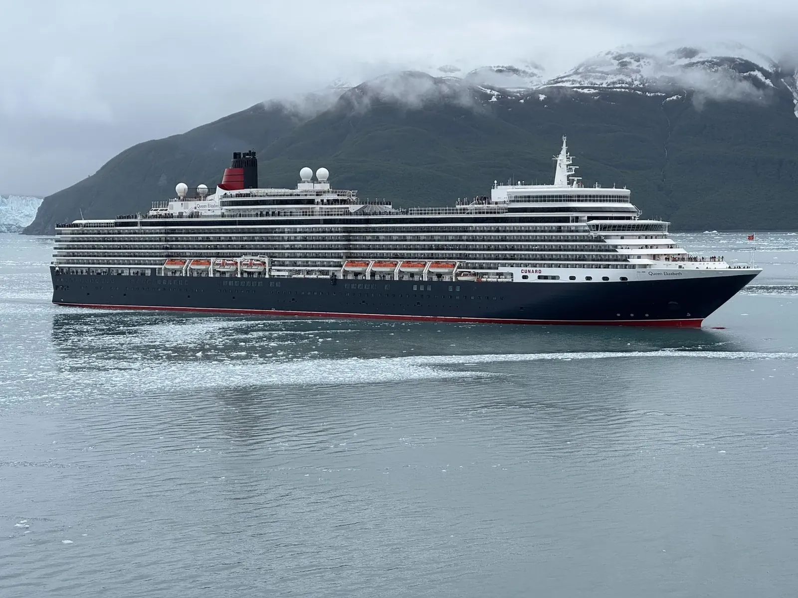 Luxury cruise ship anchored in front of an Alaskan tidewater glacier