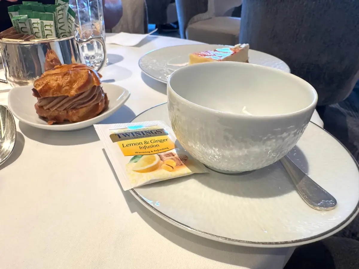 Twinings Lemon and Ginger tea with a cream puff pastry at afternoon tea on Regent Seven Seas