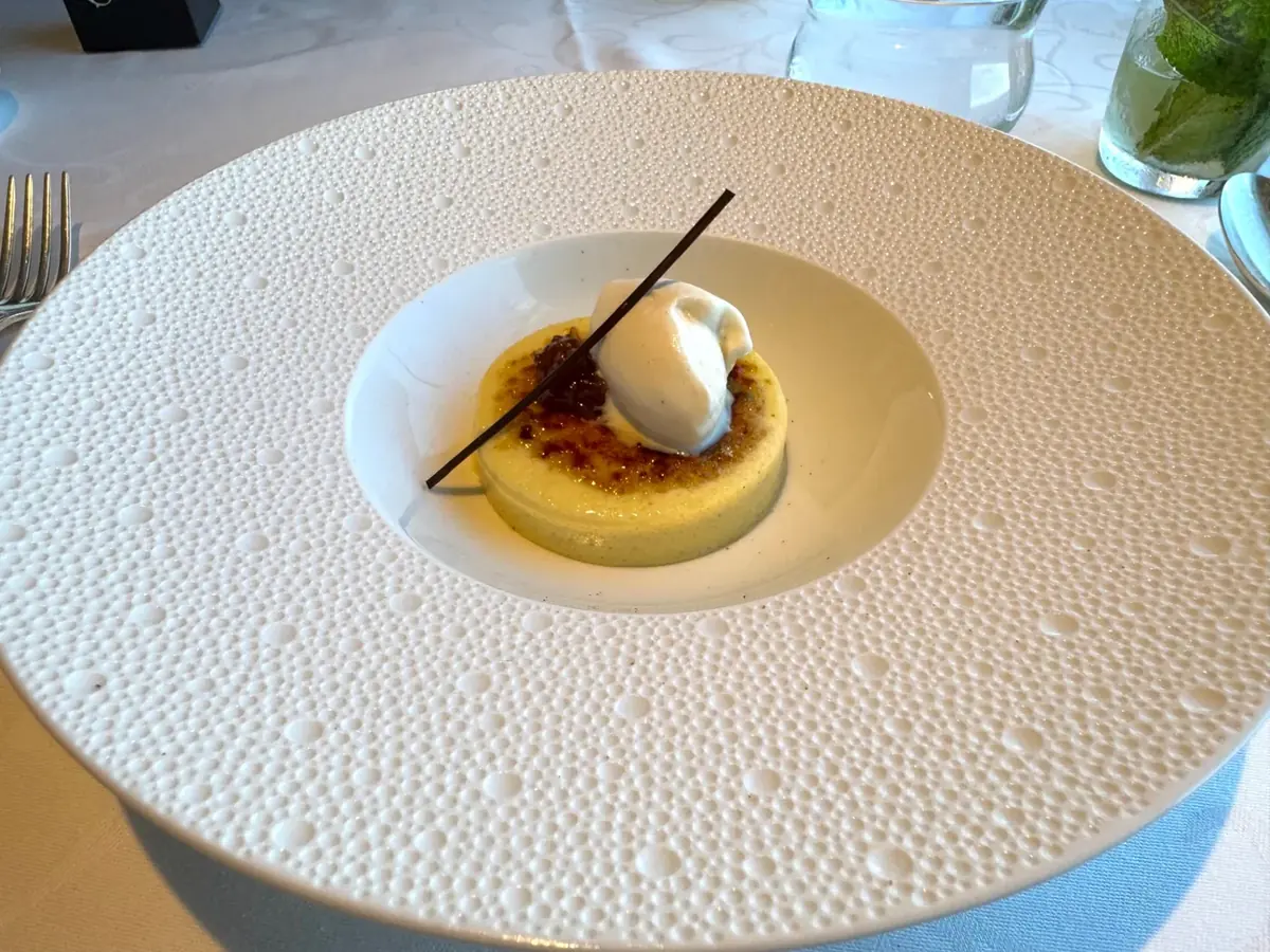Crème brûlée with vanilla bean and quenelle of cream at Chartreuse on Regent Seven Seas