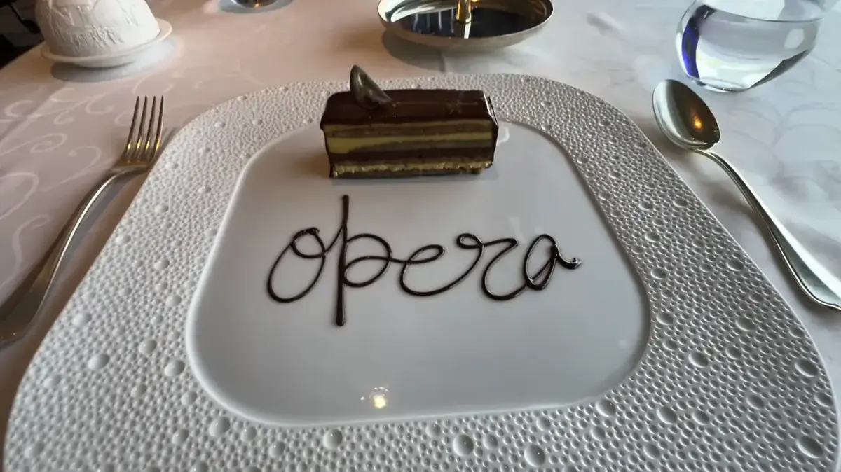 Opera cake plated with a chocolate script at Chartreuse on Regent Seven Seas