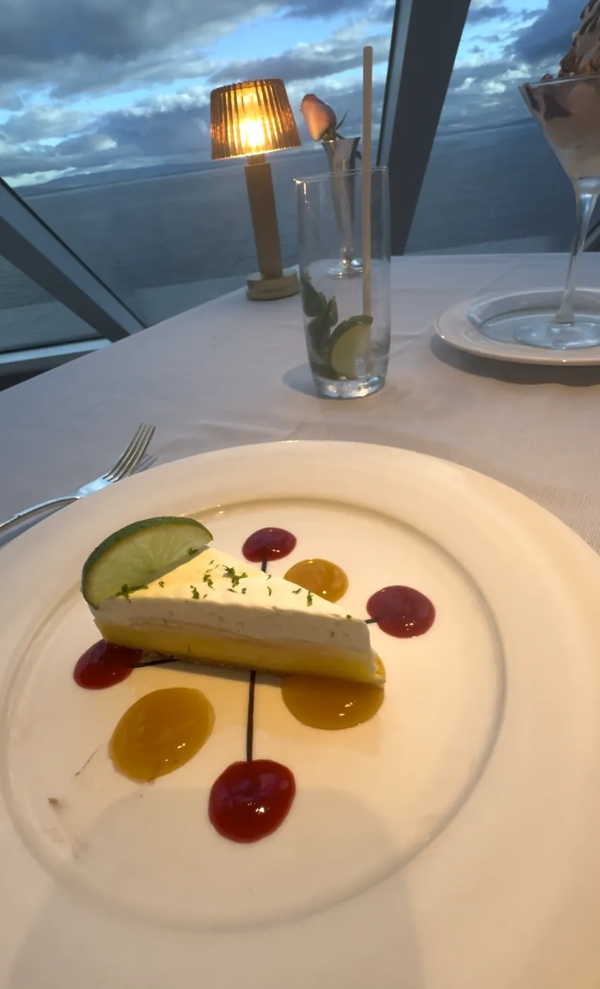Key lime pie dessert plated at Prime 7 on Regent Seven Seas with sea views at dusk