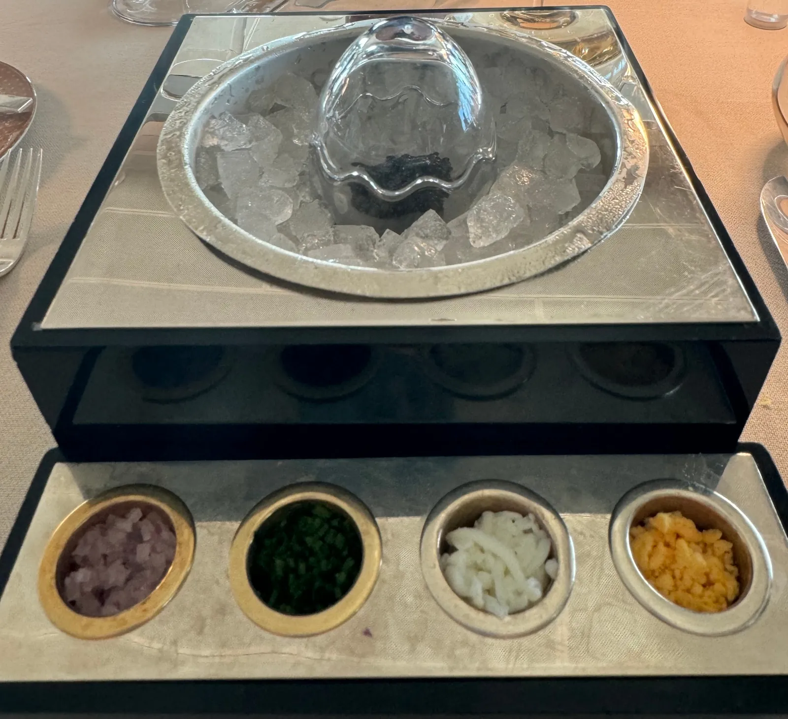 Silversea caviar service, chilled crystal bowl of Ars Italica caviar over ice with traditional accompaniments