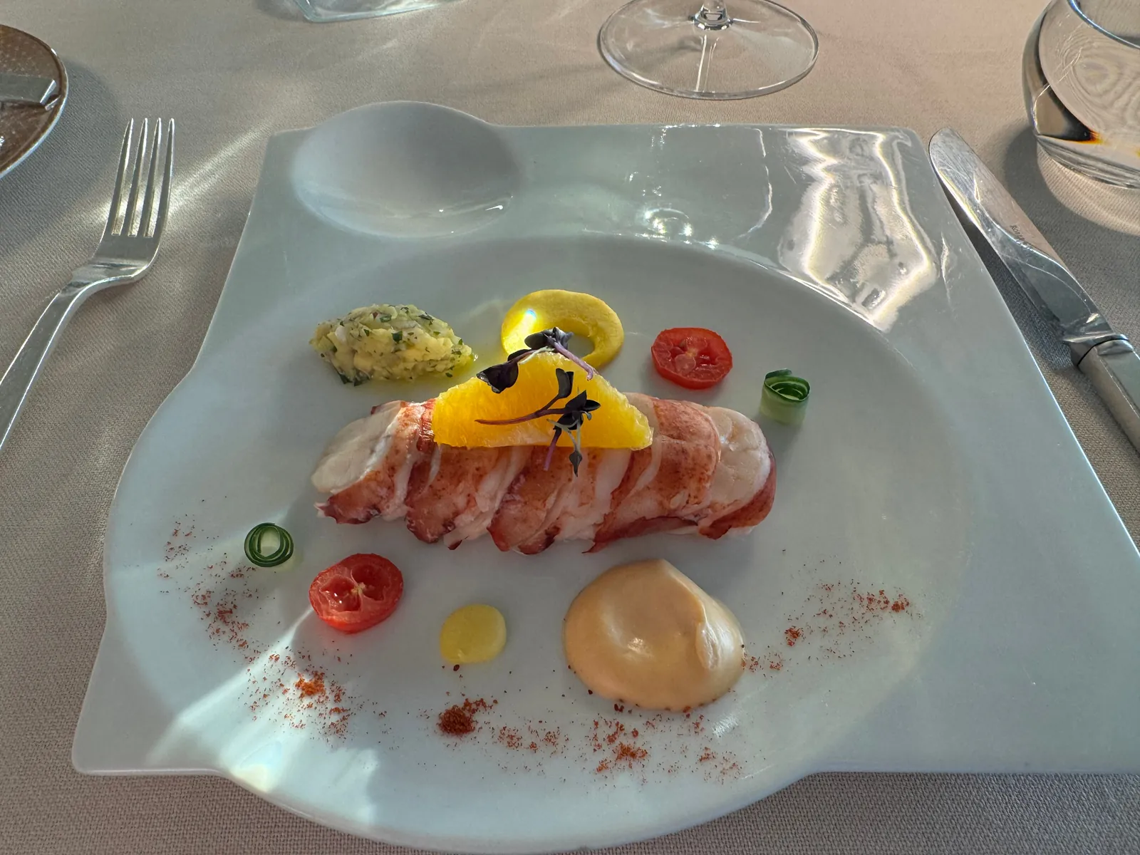 Butter-poached lobster tail with citrus and paprika on a Silversea dinner plate