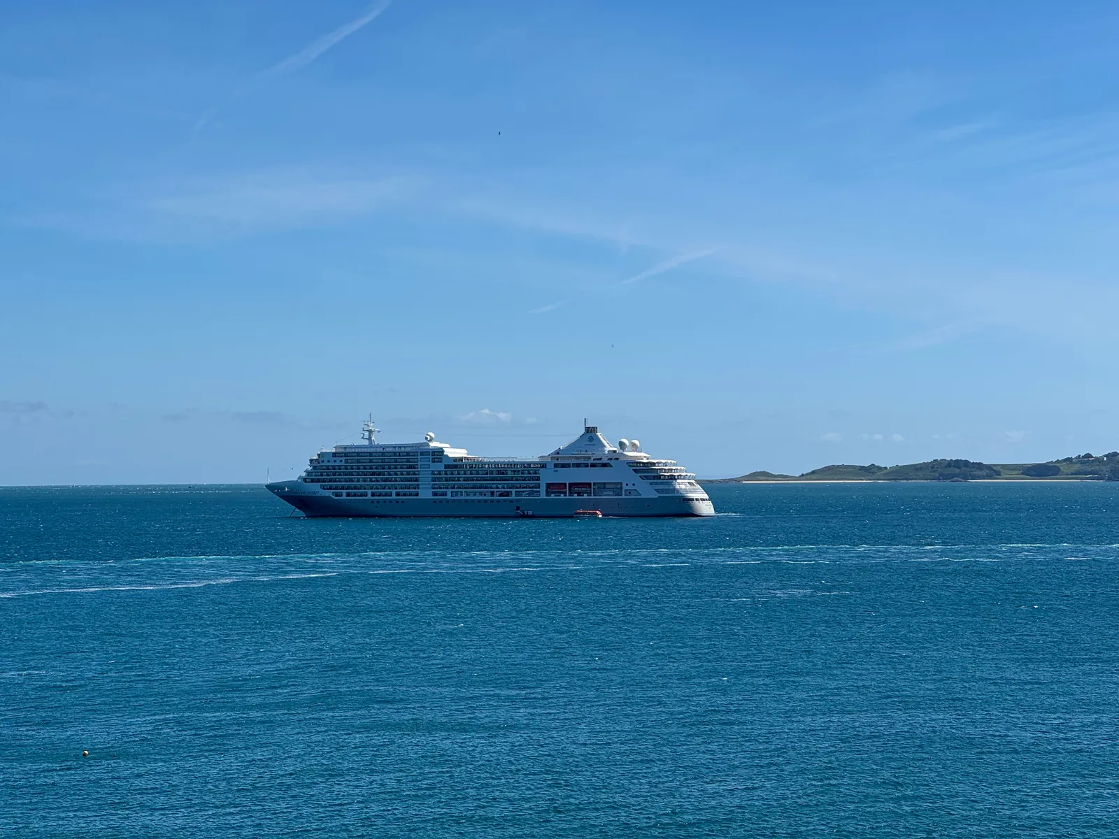 A Silversea ship sailing across bright blue water