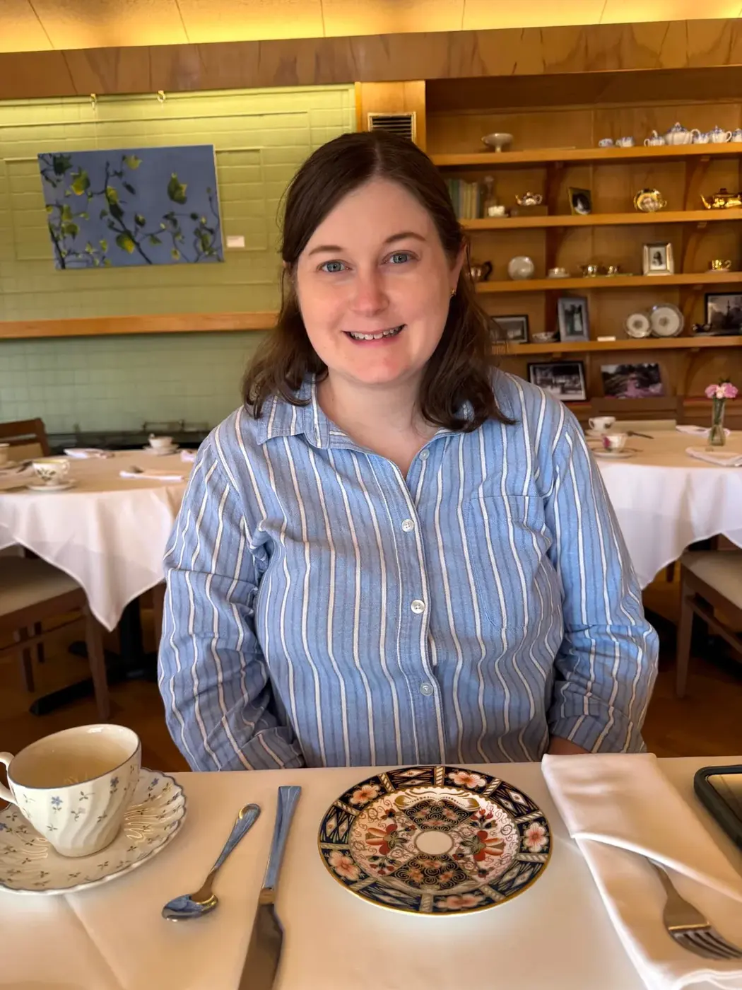 A table set for afternoon tea in Victoria, British Columbia, with china cups and patterned plates